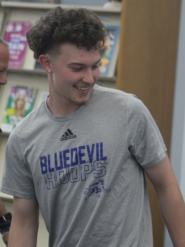 Fort Lupton's Conner Moll is all smiles after signing a letter of intent to play basketball at Keiser University May 26.